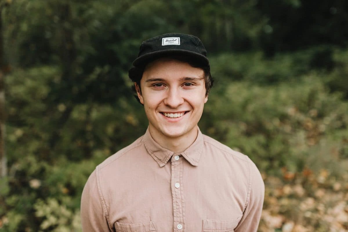 Tomasz, the editor behind Lumi, outdoors in a cap.