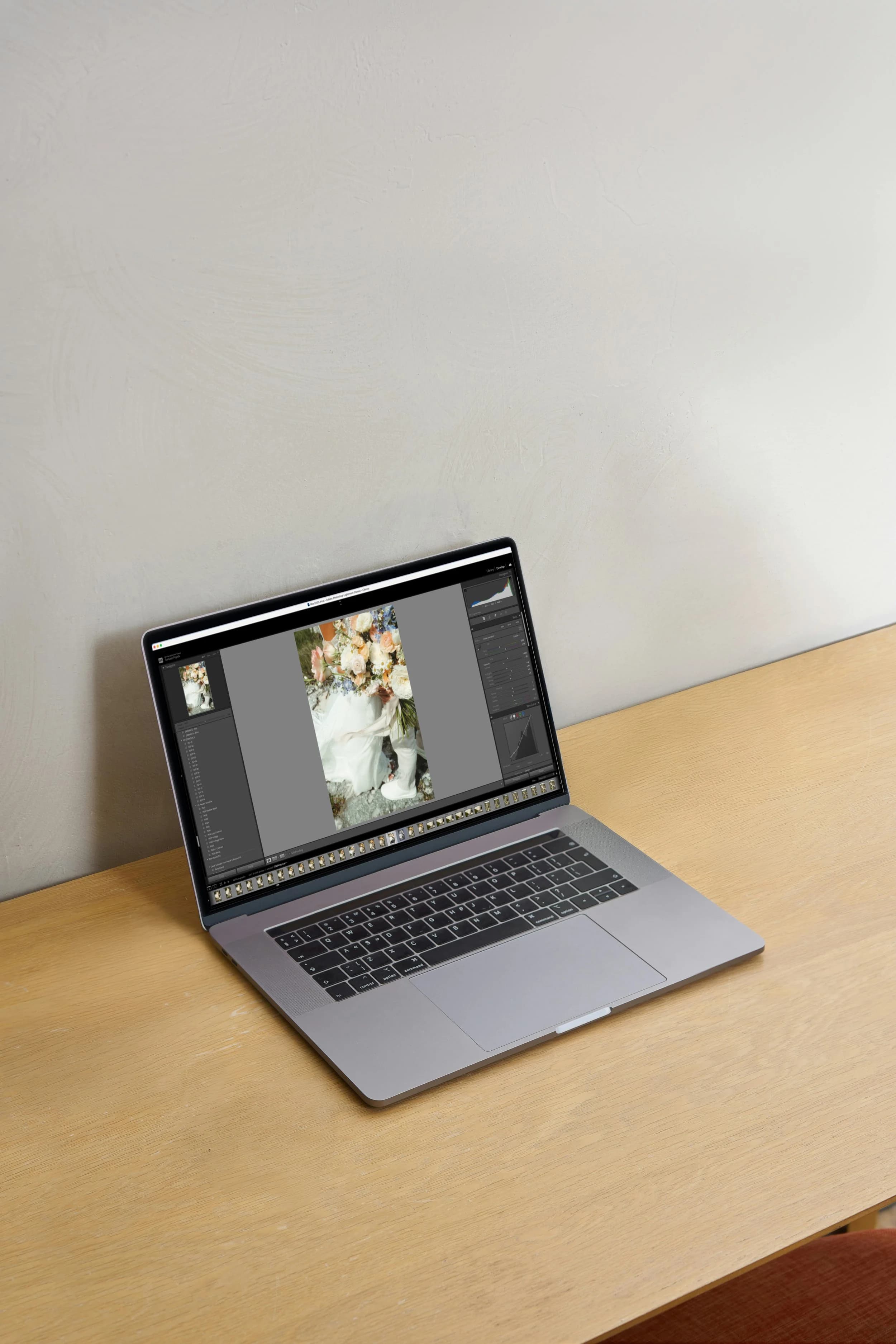 Laptop on a desk displaying photo editing software.
