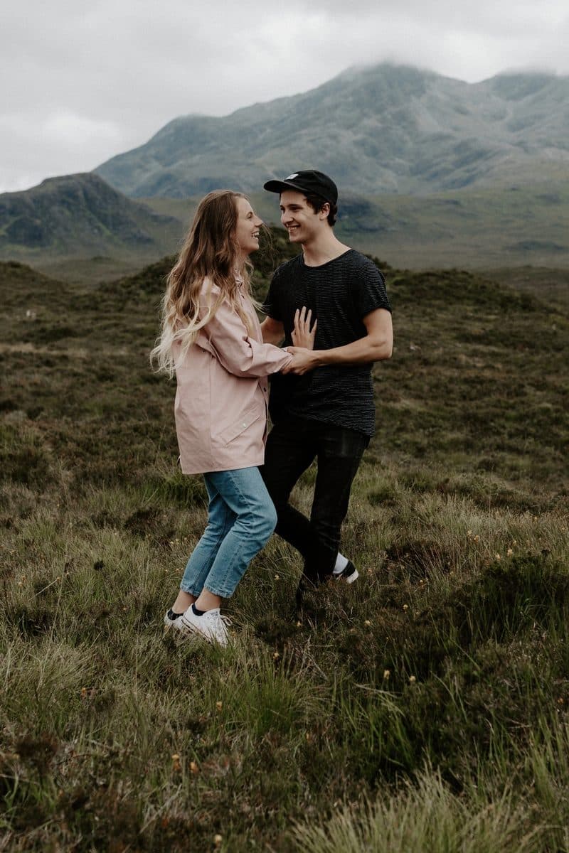 Simone and Tomasz laughing together in the Scottish Highlands.